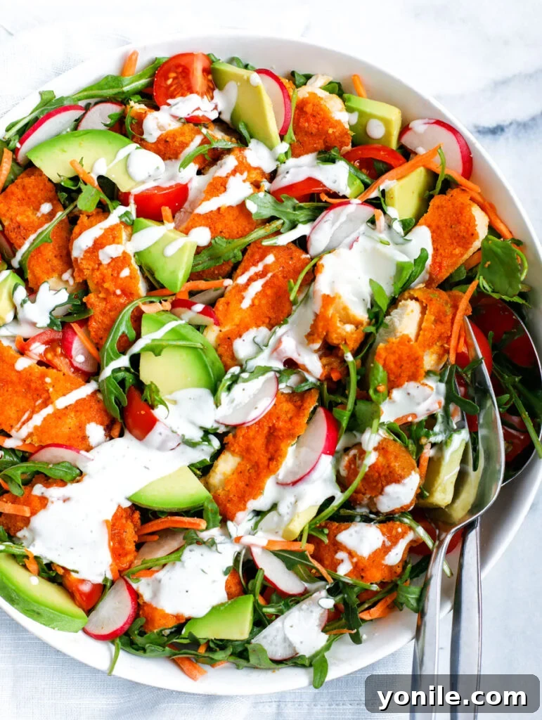 Top-down view of the beautifully assembled Crispy Buffalo Chicken Salad in a white bowl, highlighting its vibrant colors and textures.