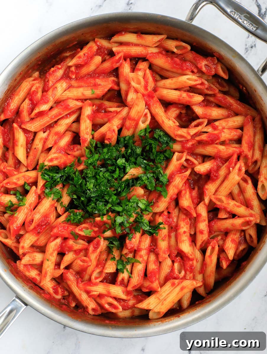 Penne pasta thoroughly mixed with the arrabbiata sauce.