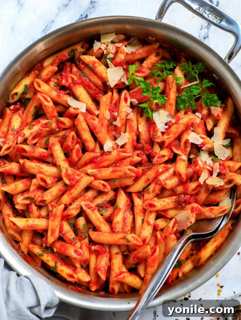 Top-down shot of spicy arrabbiata pasta in a large pot, ready to be served.