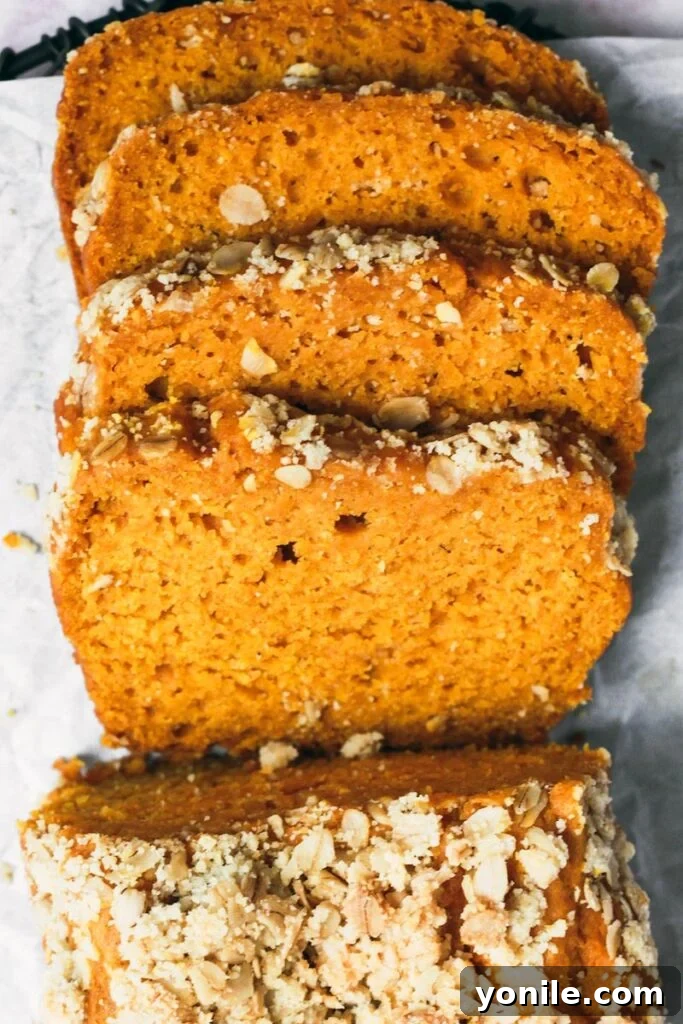 Pumpkin Quick Bread 2 Top down shot of pumpkin bread sliced, showcasing its moist texture and streusel topping.