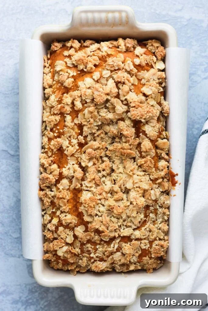 Pumpkin Quick Bread 6 Overhead shot of a baked easy pumpkin bread in a white loaf pan, ready to be cooled.