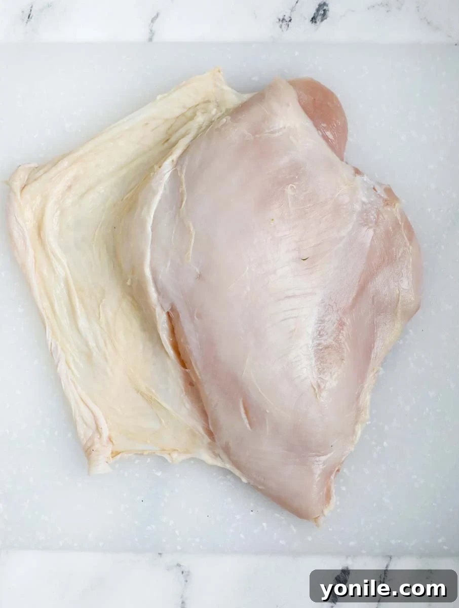 Lift up the skin of the breast without removing it completely off a turkey breast