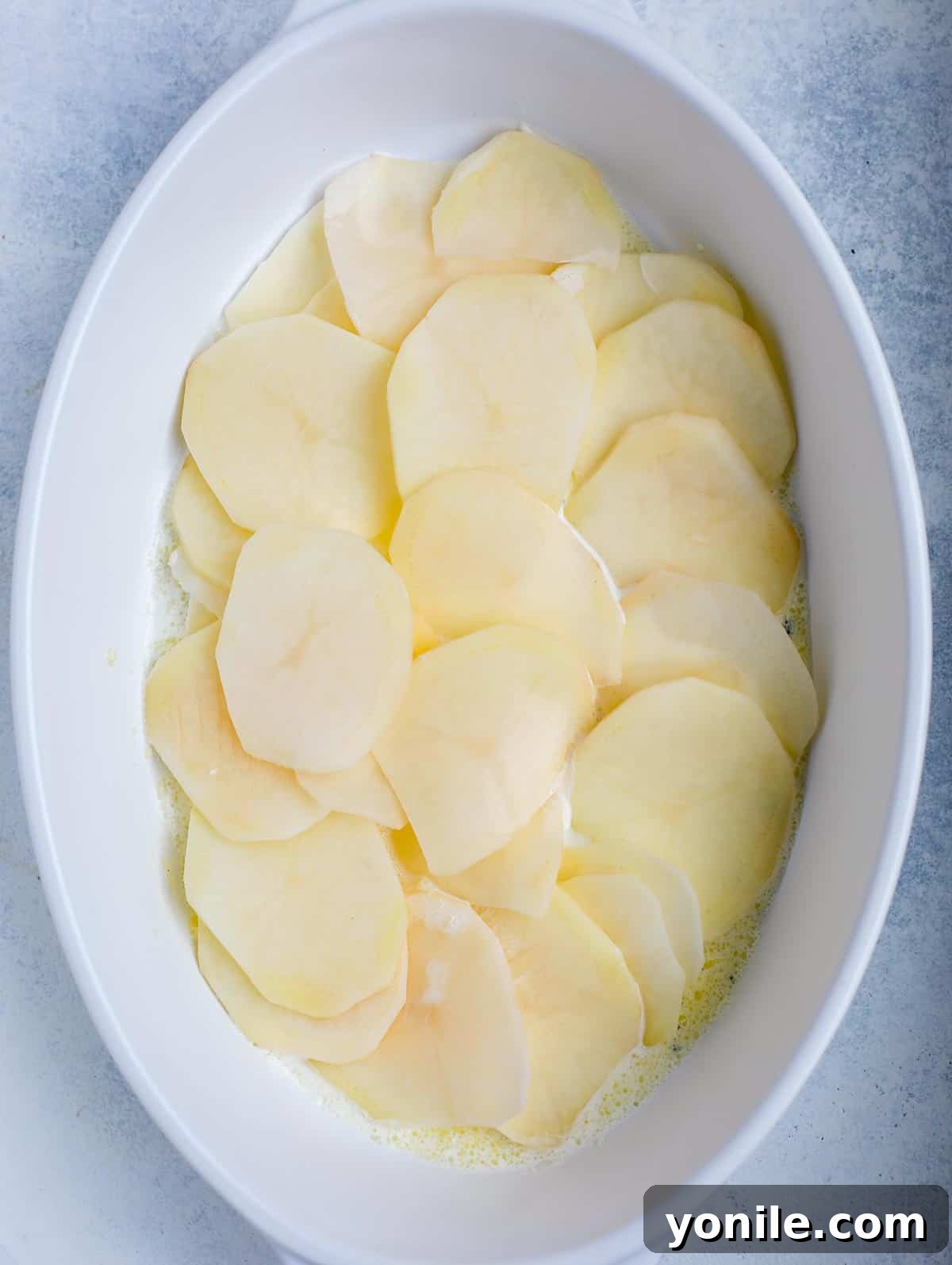 Simple Cheesy Potato Bake 5 step showing how to assemble au gratin potato
