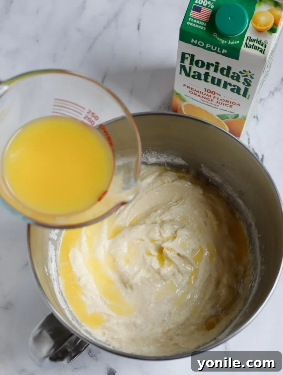 Florida's Natural orange juice being poured into the cake batter, adding essential moisture and flavor.