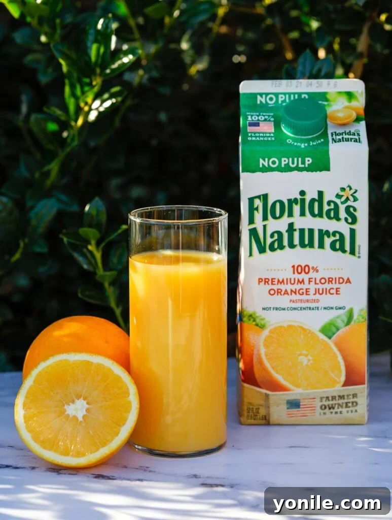 A close-up shot of a glass filled with Florida's Natural orange juice, showing its rich, natural color and inviting texture.