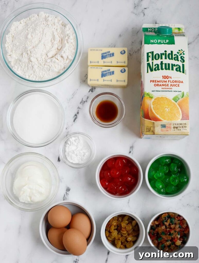 All the dry and wet ingredients for the orange fruit cake laid out neatly on a kitchen counter, ready for preparation.