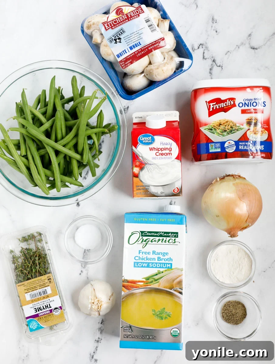 Top down shot of fresh ingredients laid out for homemade green bean casserole, including green beans, mushrooms, and cream.
