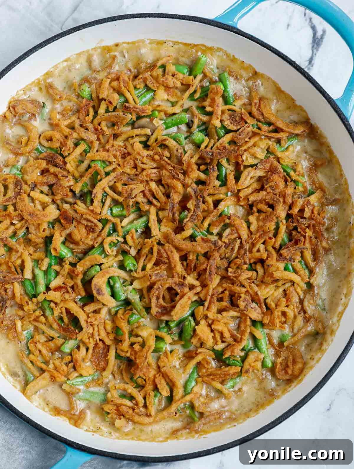 The final baked green bean casserole dish, golden and bubbly, ready to be served and enjoyed.