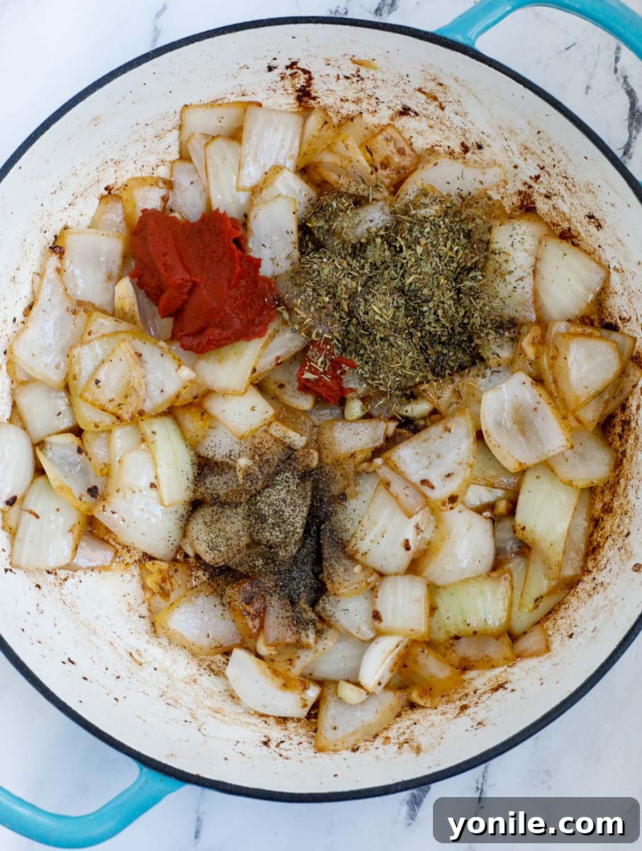 Onions and seasoning in a dutch oven