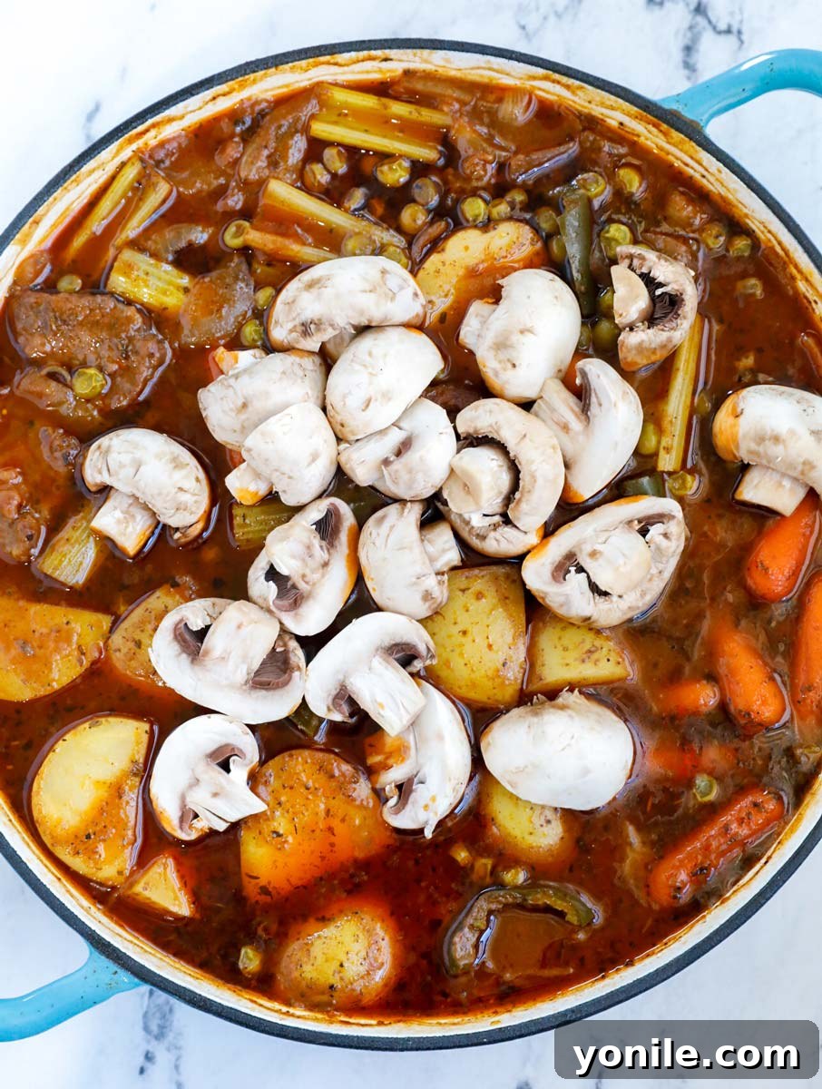 Vegetables and beef in a pot.