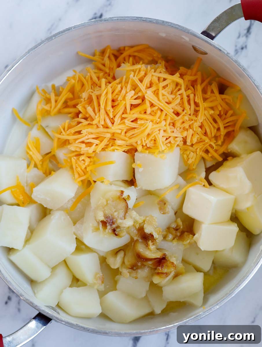 Potatoes, cheese and other ingredients in a pot.