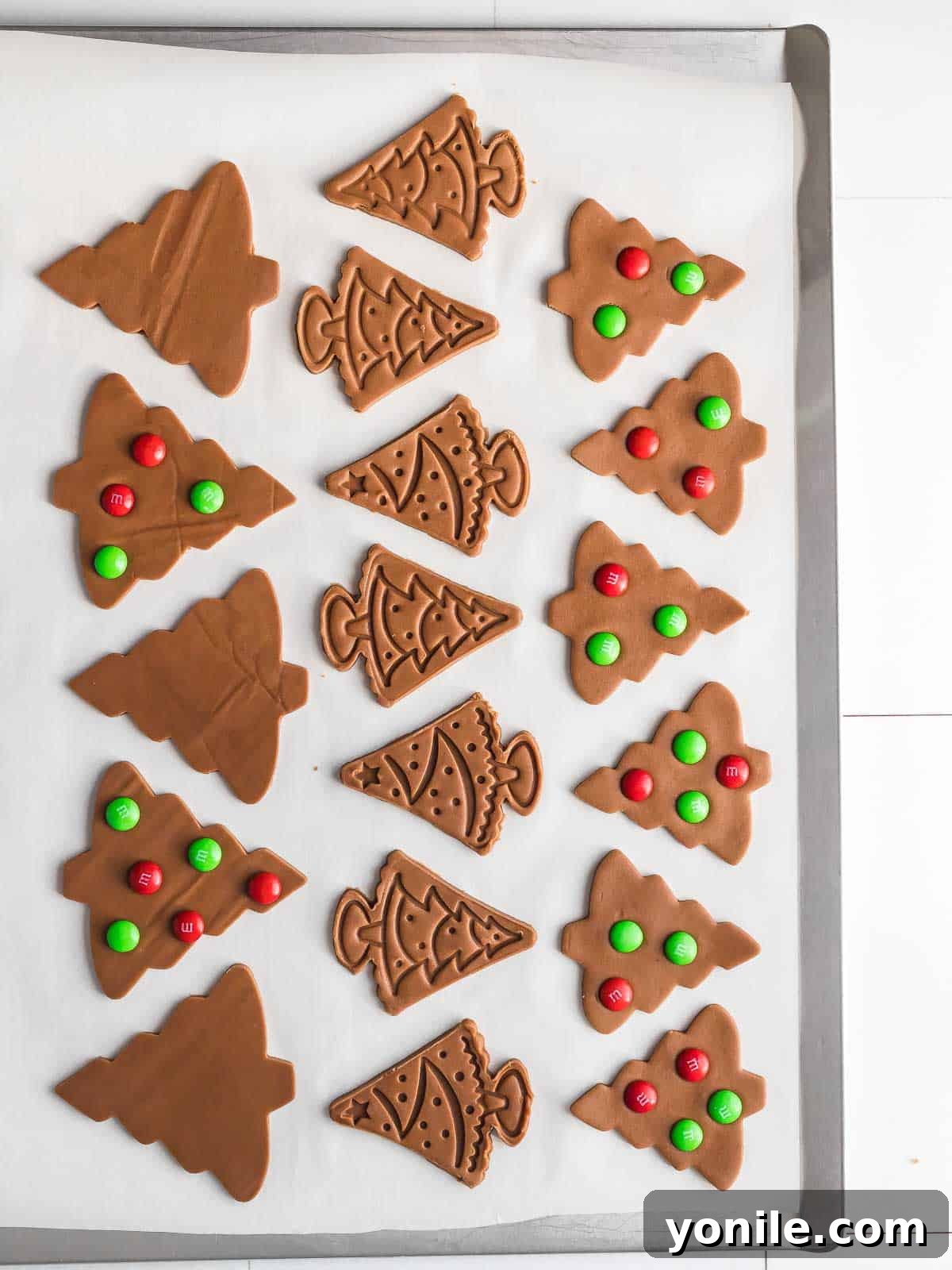 cut out cookie dough on a sheet pan with M&M's ready to bake