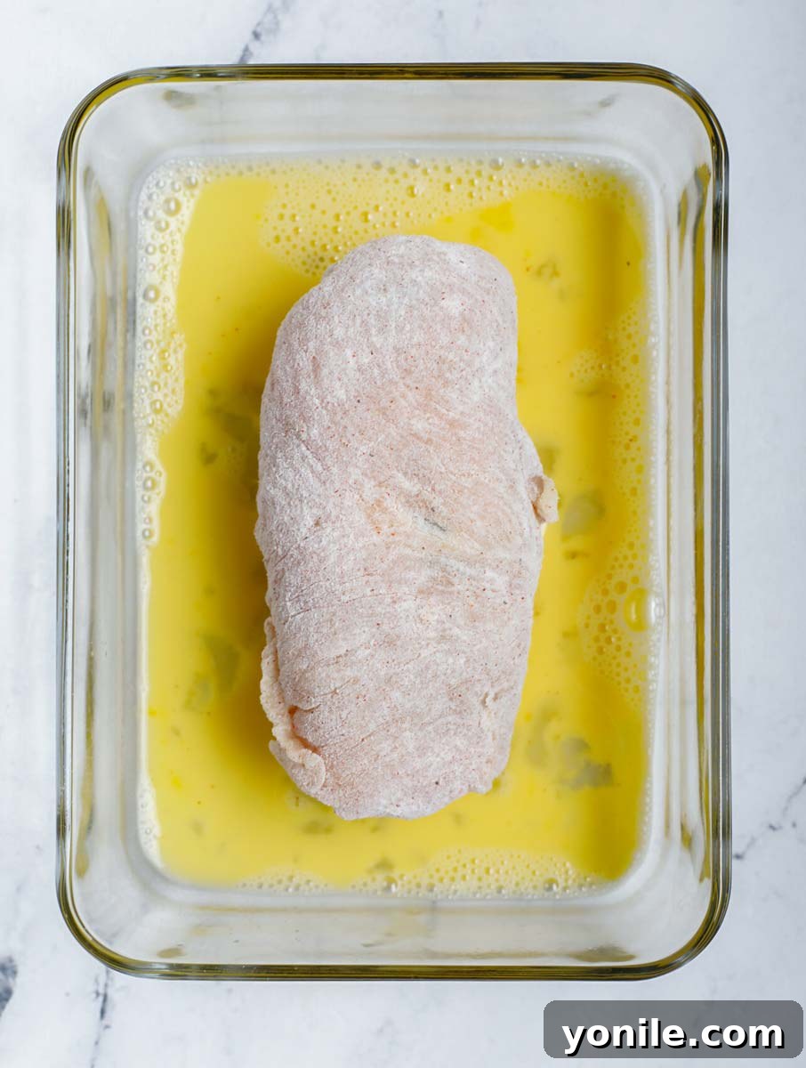 Creamy Jalapeño Chicken Popper 10 Stuffed chicken breast dipped in egg wash, prior to breading.