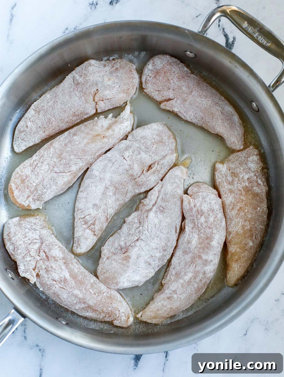 Chicken tenders in a pan.