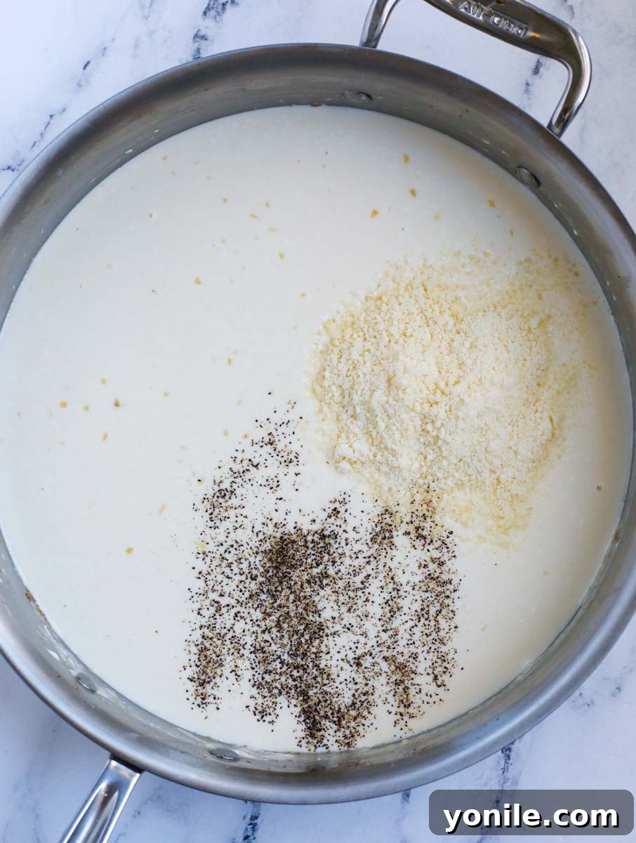 Creamy sauce with seasoning in a pot.