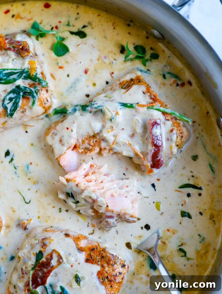 Overhead shot of creamy Tuscan salmon served in a skillet, ready to eat.