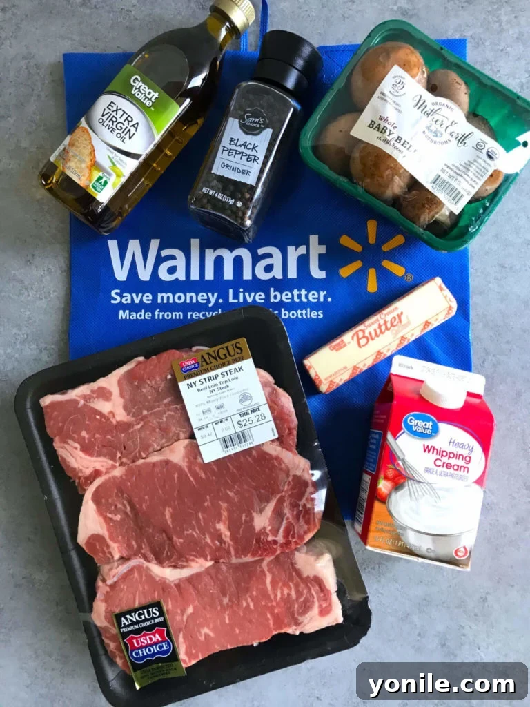 Selection of ingredients for creamy mushroom steak: olive oil, black pepper, mushrooms, steak, butter, and heavy whipping cream
