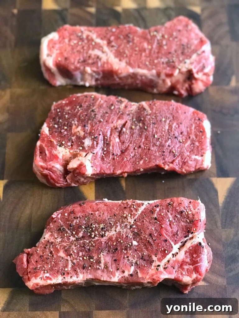 Steak marinating with salt and pepper rubbed on it before cooking