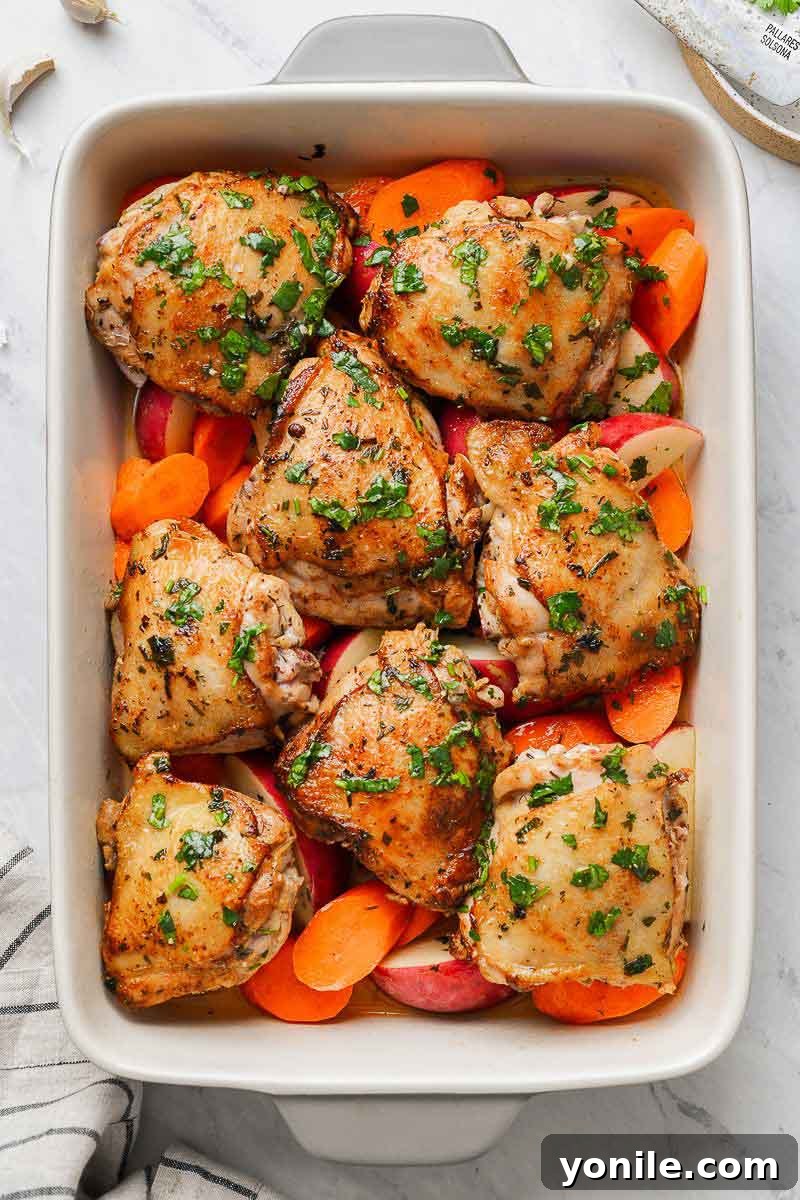Chicken thighs in a baking dish with veggies