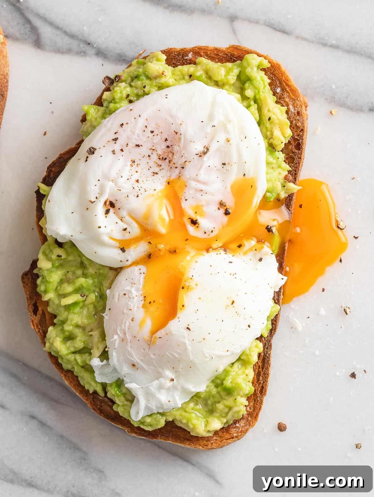 The Perfect Avocado and Egg Toast 6 Avocado spread on a slice of hearty toast, crowned with a perfectly cooked poached egg, its delicate white encasing a soft, vibrant yolk.