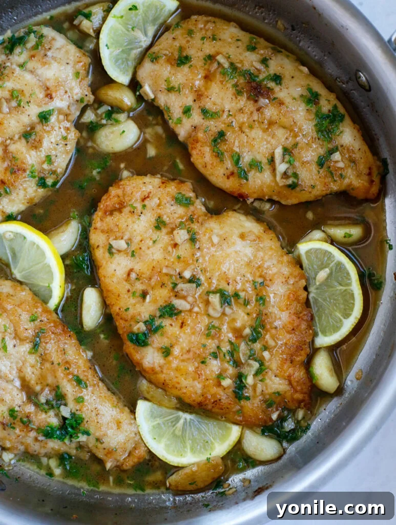 Overhead shot of a vibrant lemon garlic chicken skillet, ready to be enjoyed.