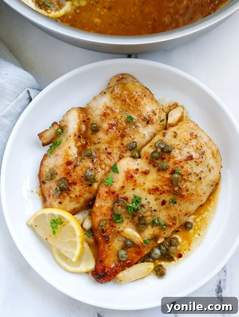 chicken piccata pieces on a white plate