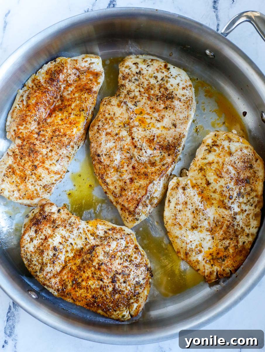 Zesty Greek Skillet Chicken 5 Top down shot of chicken breasts in a pot.