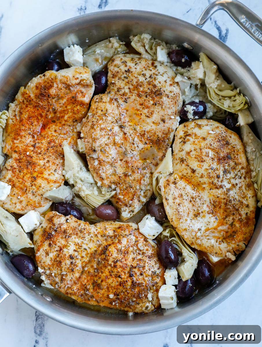 Zesty Greek Skillet Chicken 6 Chicken in a pot with olives.