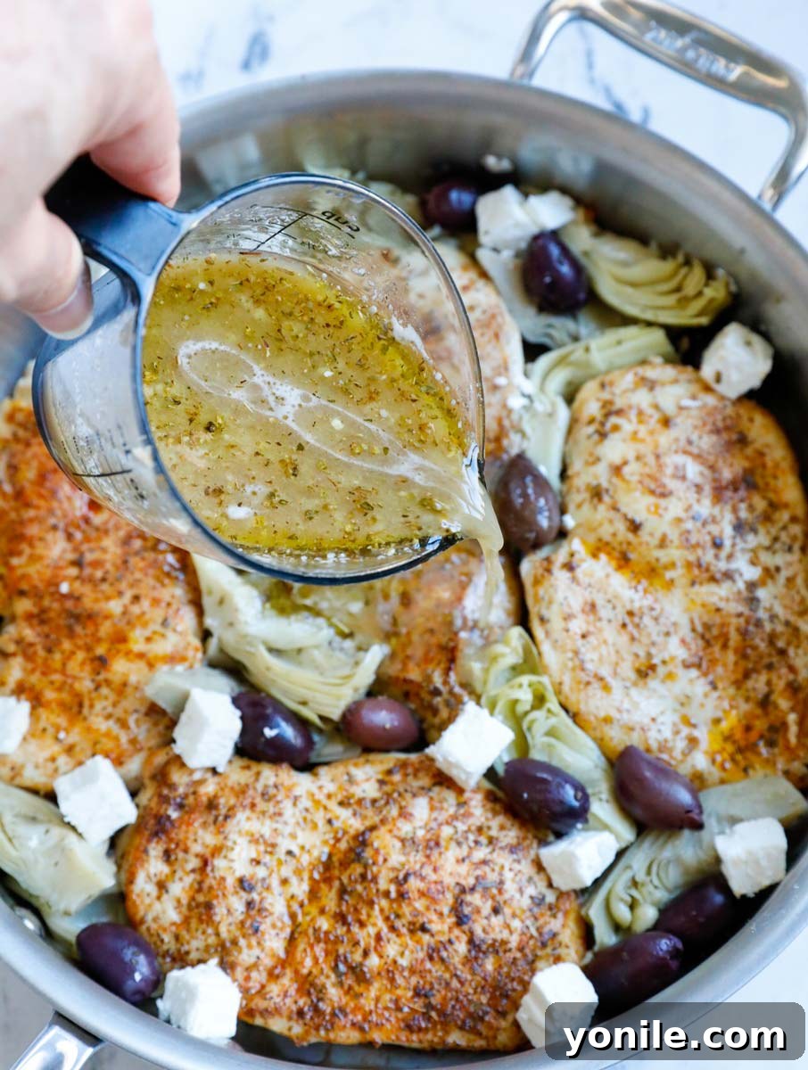Zesty Greek Skillet Chicken 7 Pouring marinade onto chicken in a pot