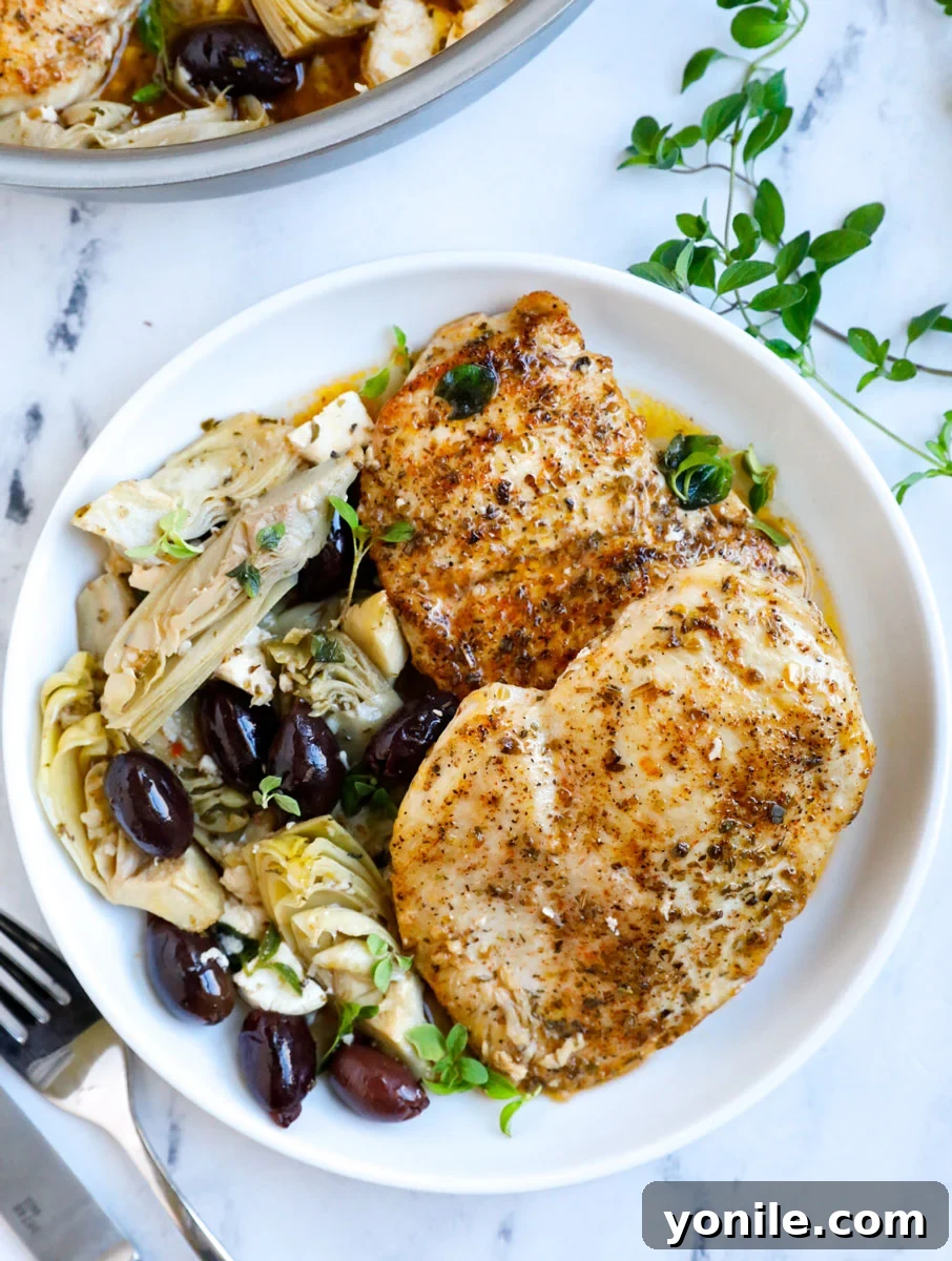 Zesty Greek Skillet Chicken 8 greek chicken breasts served on a white plate
