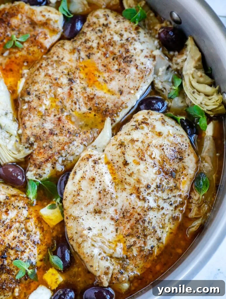 Zesty Greek Skillet Chicken 9 Overhead shot of greek chicken in a skillet with olives and artichokes.