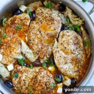 Top down shot of greek chicken in a skillet.