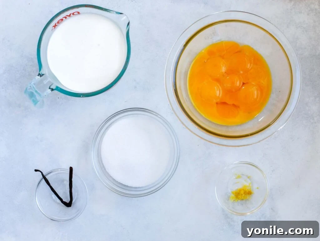 Top-down view of fresh ingredients laid out for making crème brûlée, including eggs, cream, vanilla, and sugar.