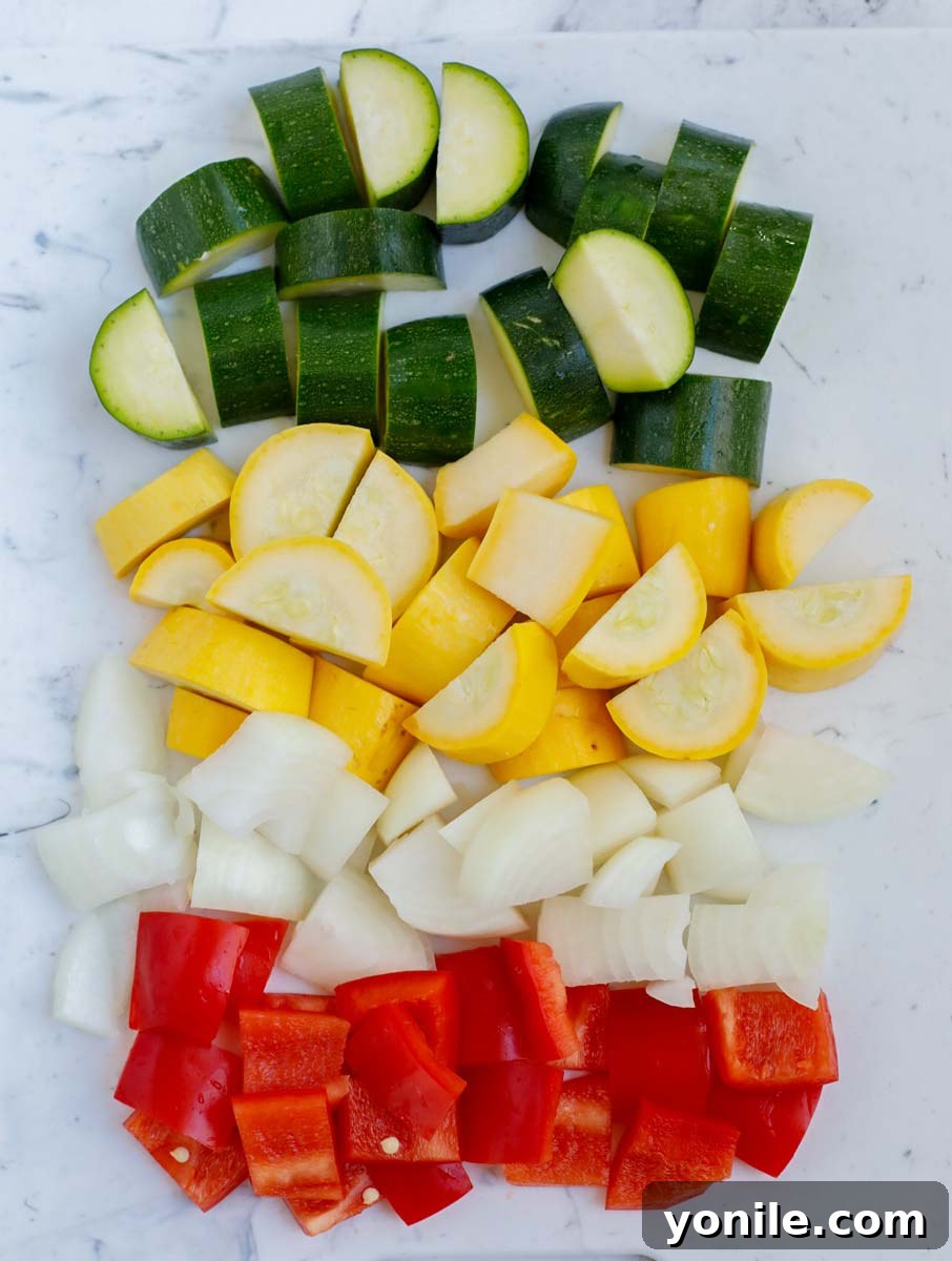 Diced zucchini, yellow squash, red pepper, and onion ready to be added to shrimp.