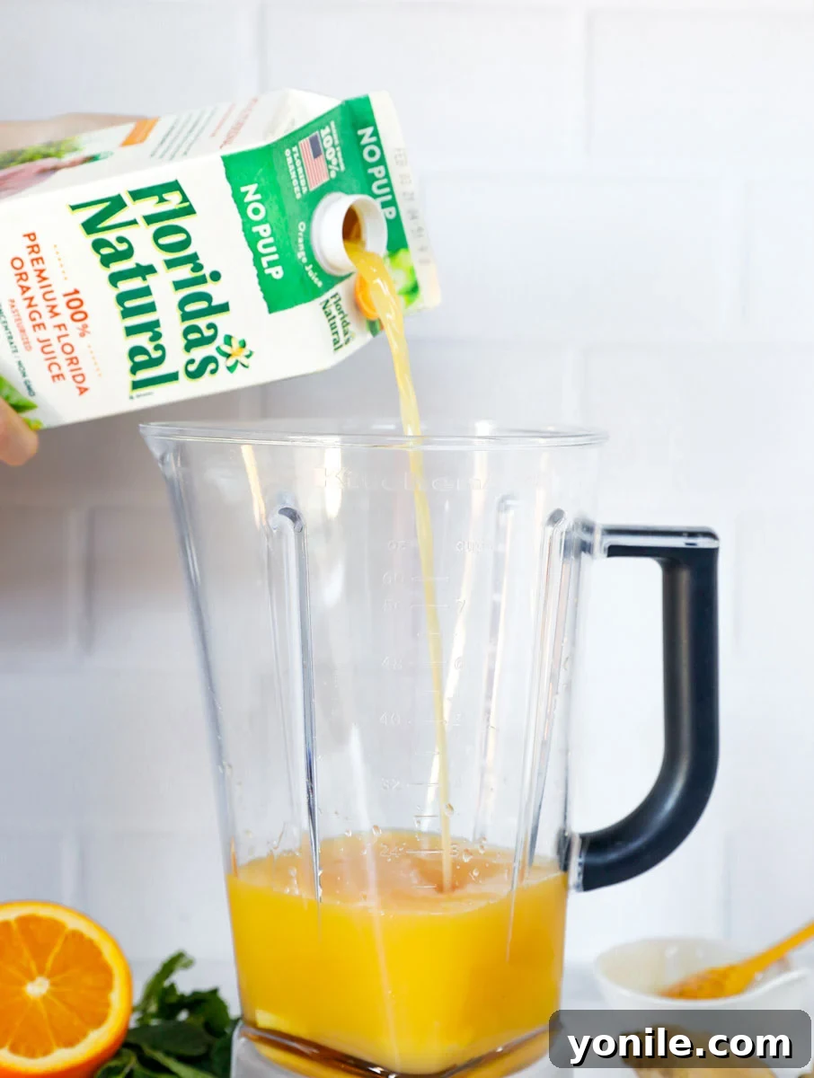 Citrus Immune Shield 5 Fresh ginger, turmeric, and honey are being blended, with Florida's Natural orange juice being poured into the blender to create the immune-boosting drink.
