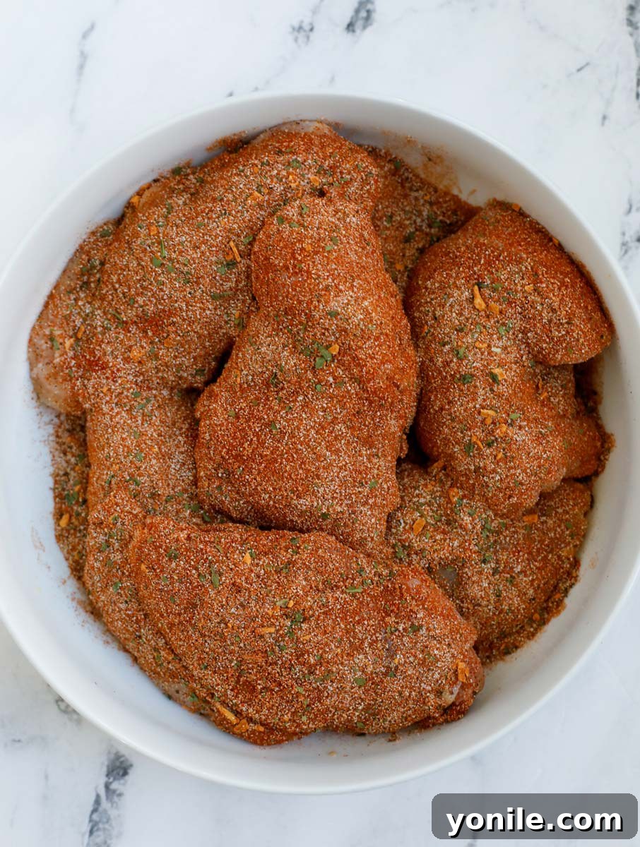Crispy Air Fryer Chicken Thighs 4 Raw chicken thighs in a bowl, before seasoning.