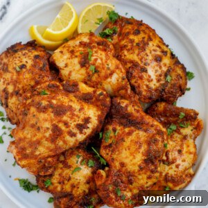Overhead shot of air fryer boneless chicken thighs on a plate.