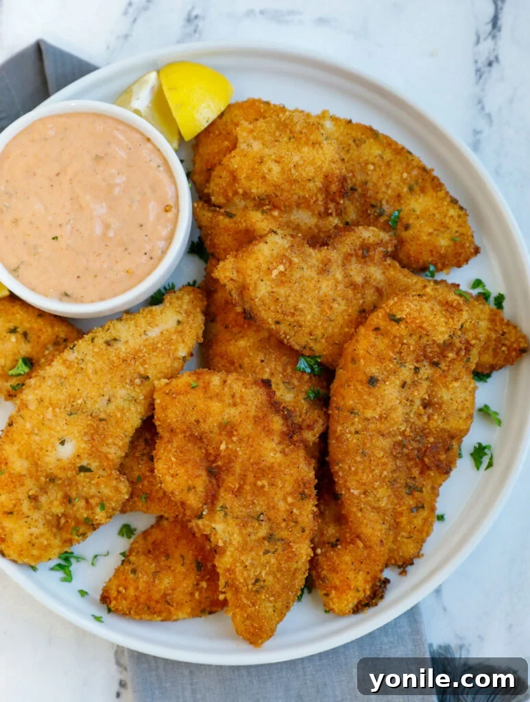 Crispy Air Fryer Chicken Strips served on a plate with a special dipping sauce.