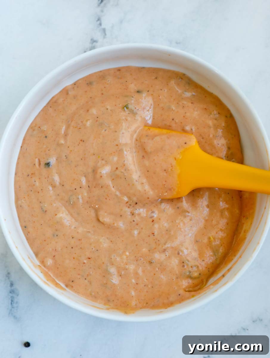 The special sauce being expertly mixed in a bowl.