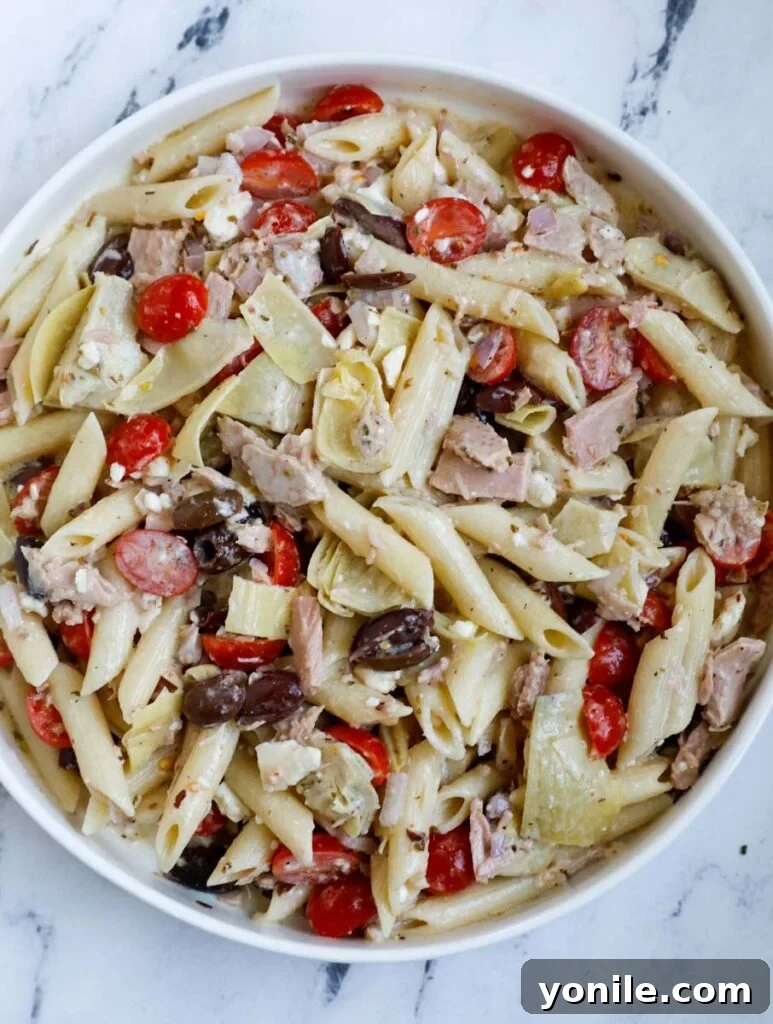 Mediterranean Tuna Pasta Salad 5 Top down shot of the finished Greek tuna pasta salad in a big serving bowl, garnished and ready to eat.