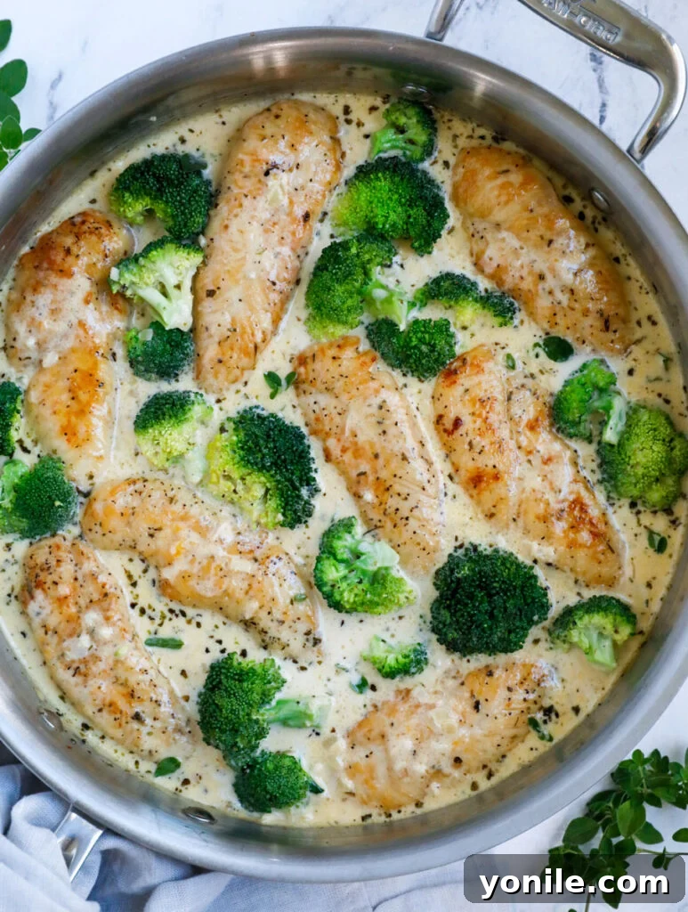 Top down view of creamy broccoli chicken in a large pot, garnished and ready to serve.