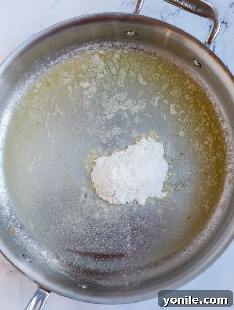 Dreamy Creamy Pesto Chicken 5 Butter melting in a pan with flour being added.