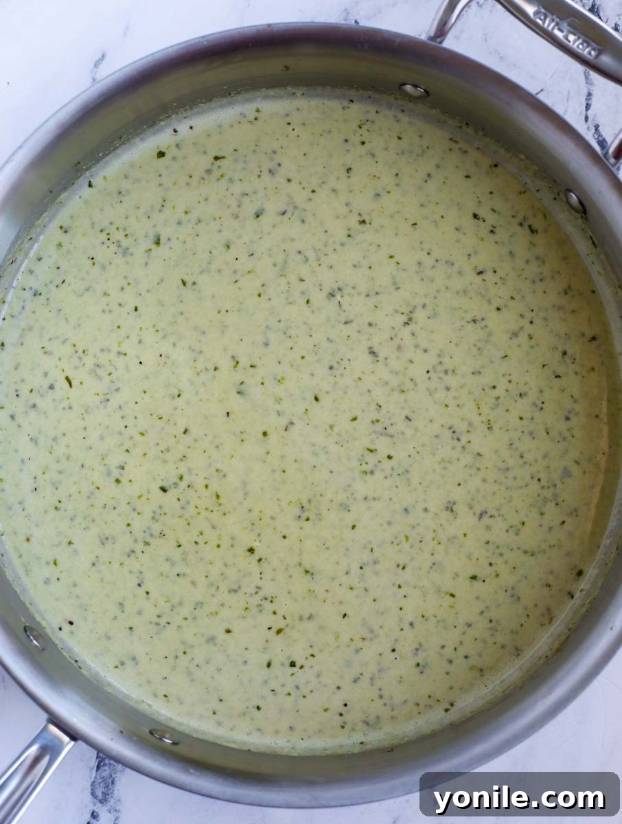 Dreamy Creamy Pesto Chicken 8 Pesto sauce simmering in a pan, thickening beautifully.