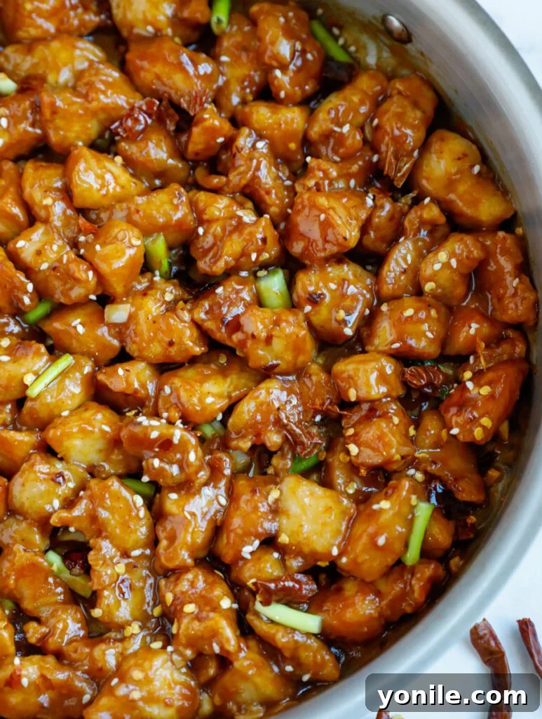 No Fuss General Tsos Chicken 12 Close up of a skillet with bite sized pieces of general tso chicken, perfectly coated and ready to serve.