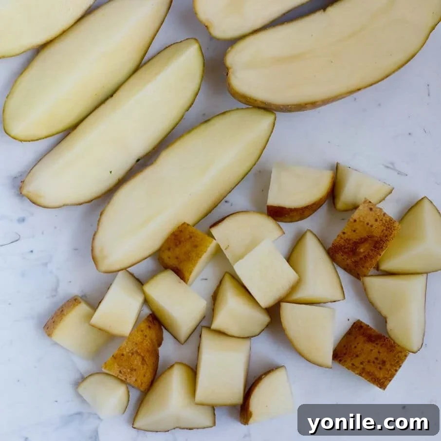 Crispy Air Fryer Potato Cubes 4 How to cut up potatoes into cubes and rinse them in a bowl before air frying.