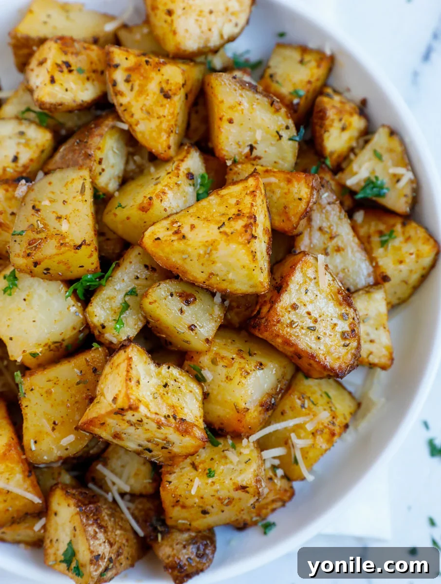 Crispy Air Fryer Potato Cubes 8 A close-up overhead shot of a plate brimming with perfectly roasted, golden-brown diced air fryer potatoes, ready to be enjoyed.