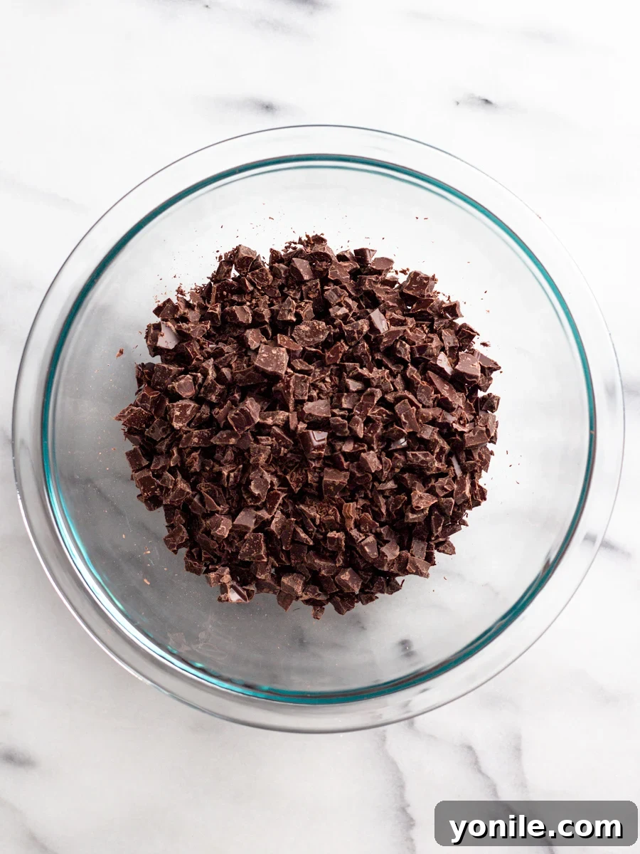 Mastering Chocolate Ganache 4 Finely chopped chocolate pieces ready in a bowl, awaiting the hot cream.
