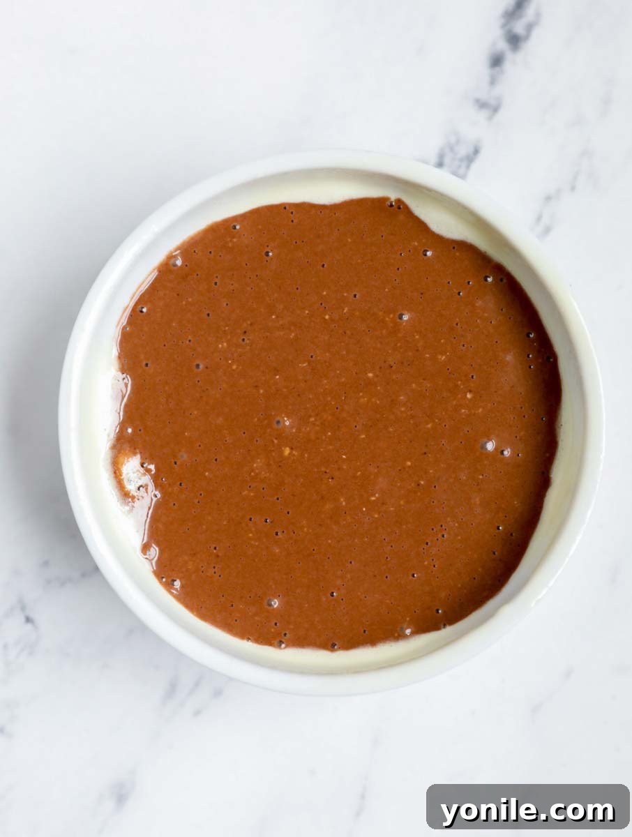 Chocolate peanut butter baked oats batter in a ramekin.