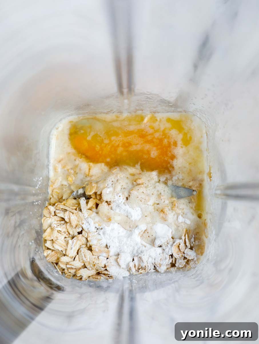 Rainbow Oat Cake Delight 5 All liquid and dry ingredients in a blender, ready to be blended for baked oats.