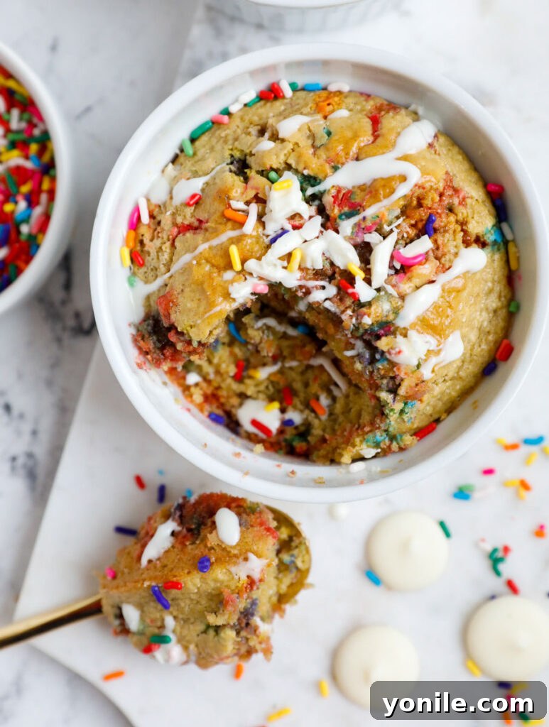 Rainbow Oat Cake Delight 9 Baked funfetti oat cake with a spoonful scooped out, showing its fluffy interior.